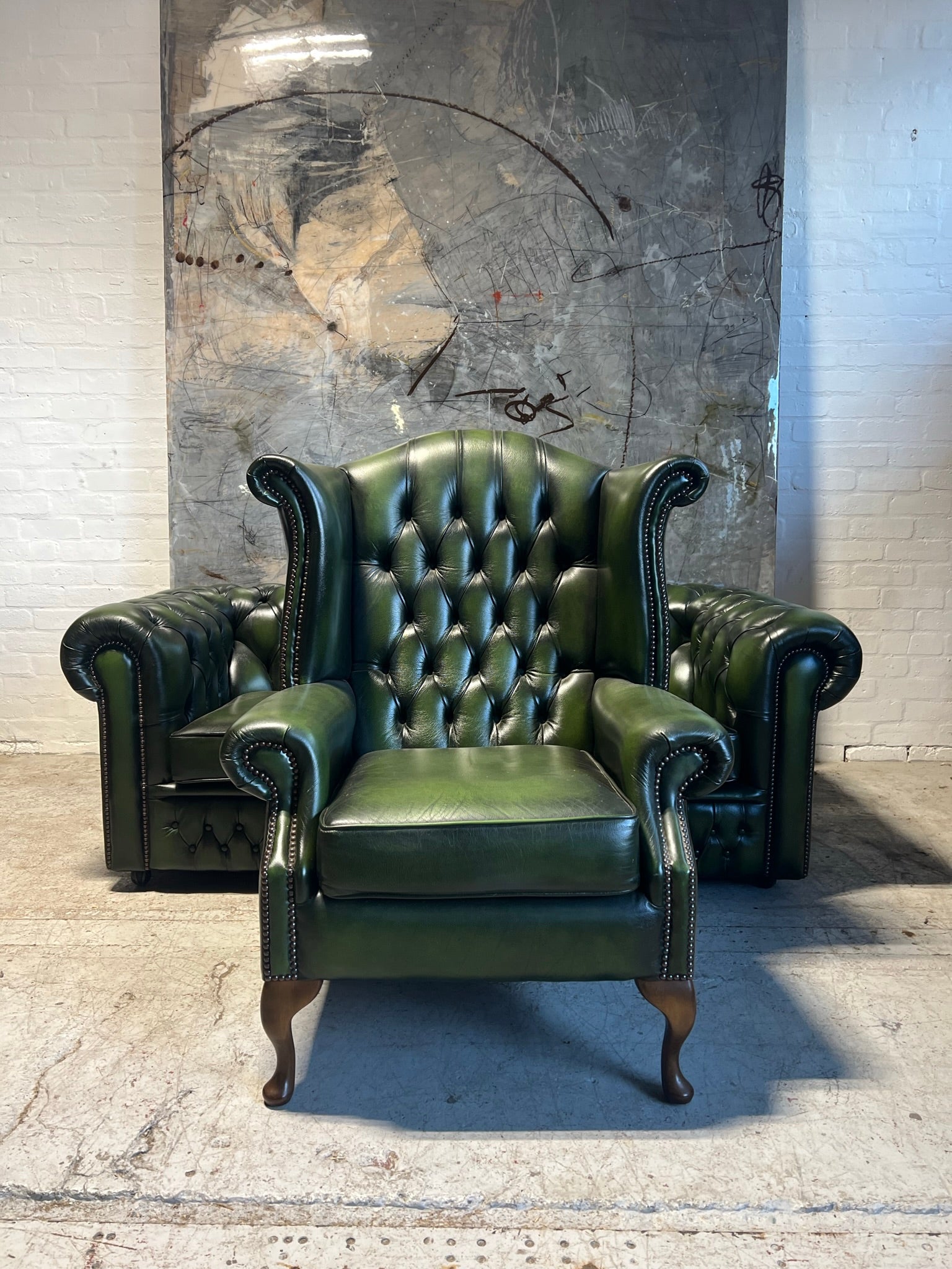 A Rich Green Leather Chesterfield Wing Back Chair