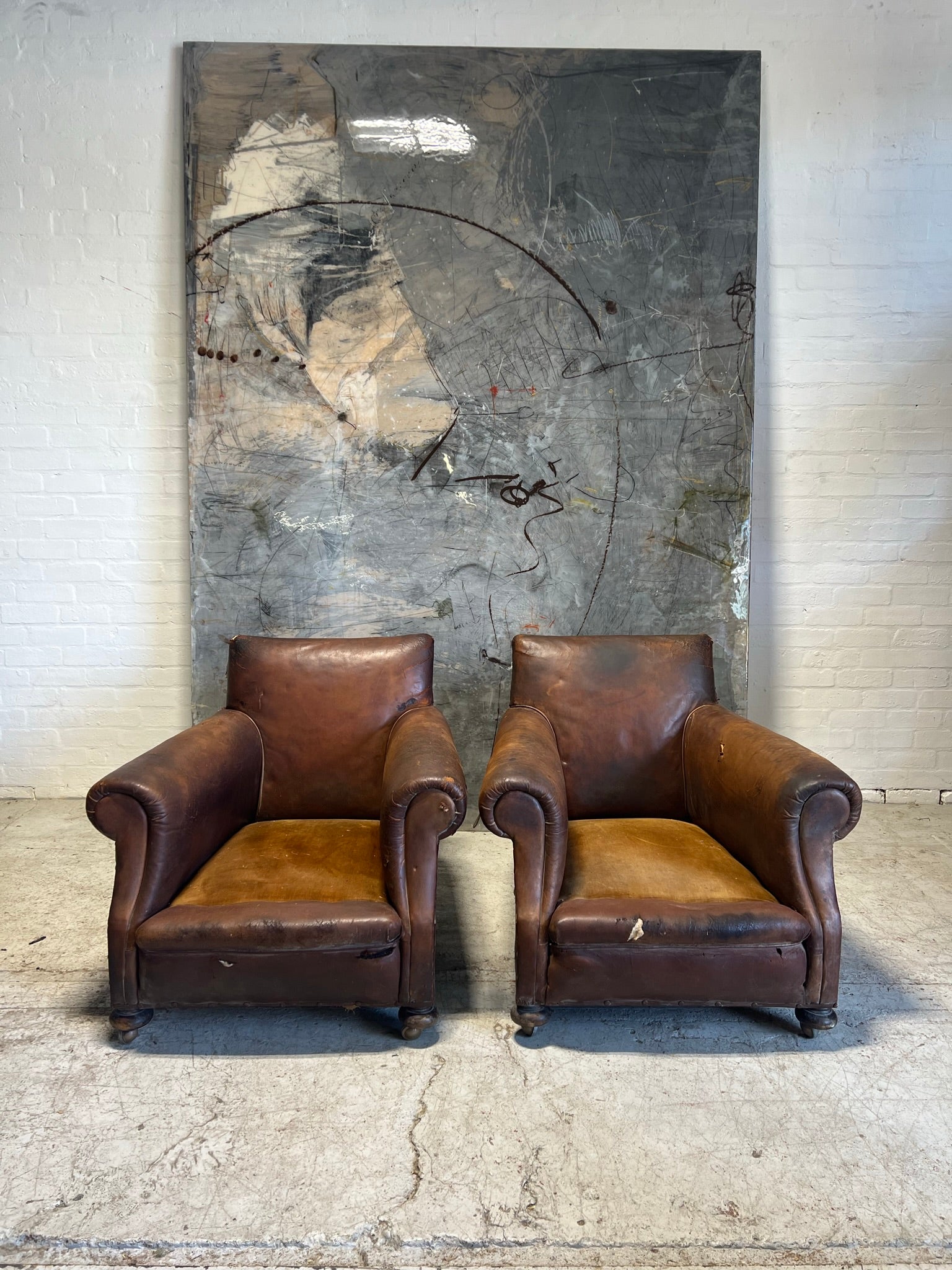 A Robust Pair of Edwardian Armchairs in Original Leather