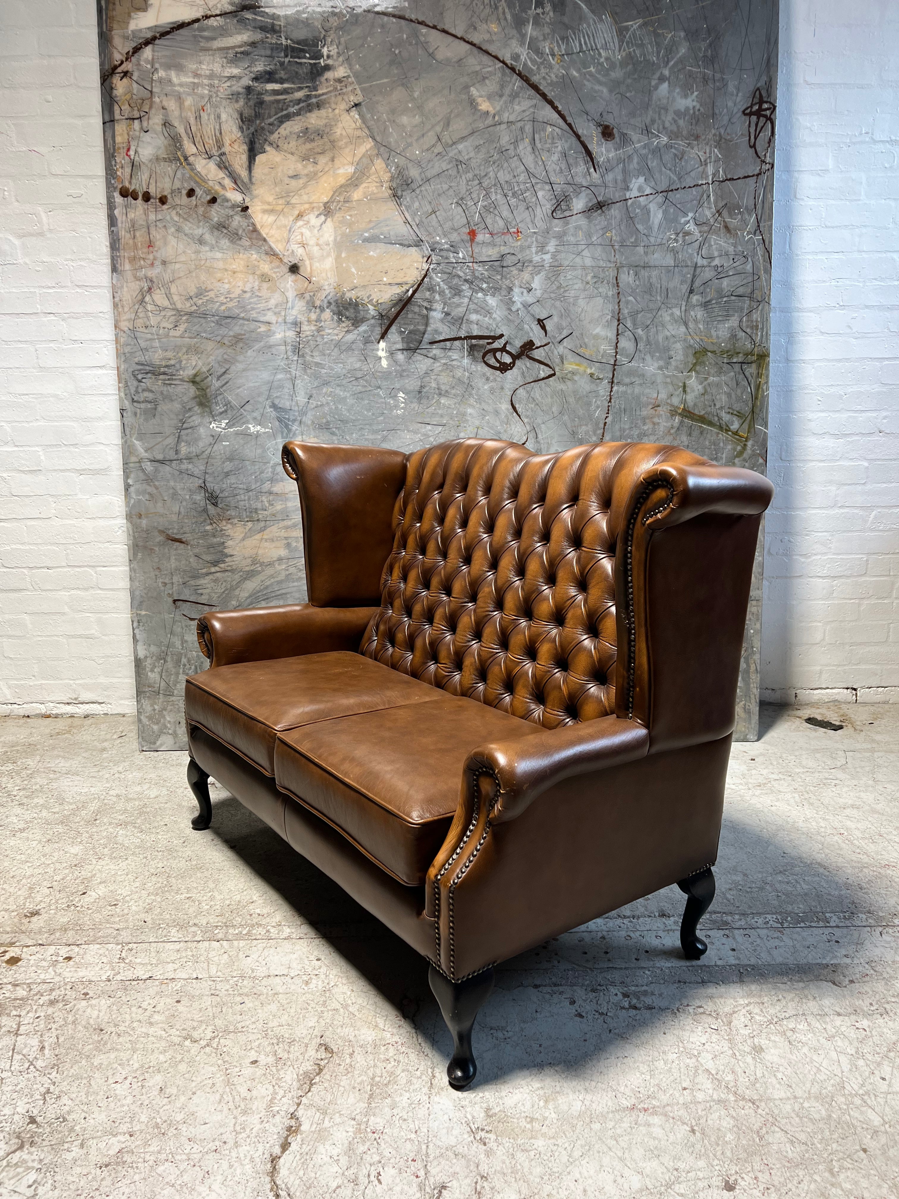 A Great Value 2 Seater Leather Wing Back Sofa in Caramel Tans