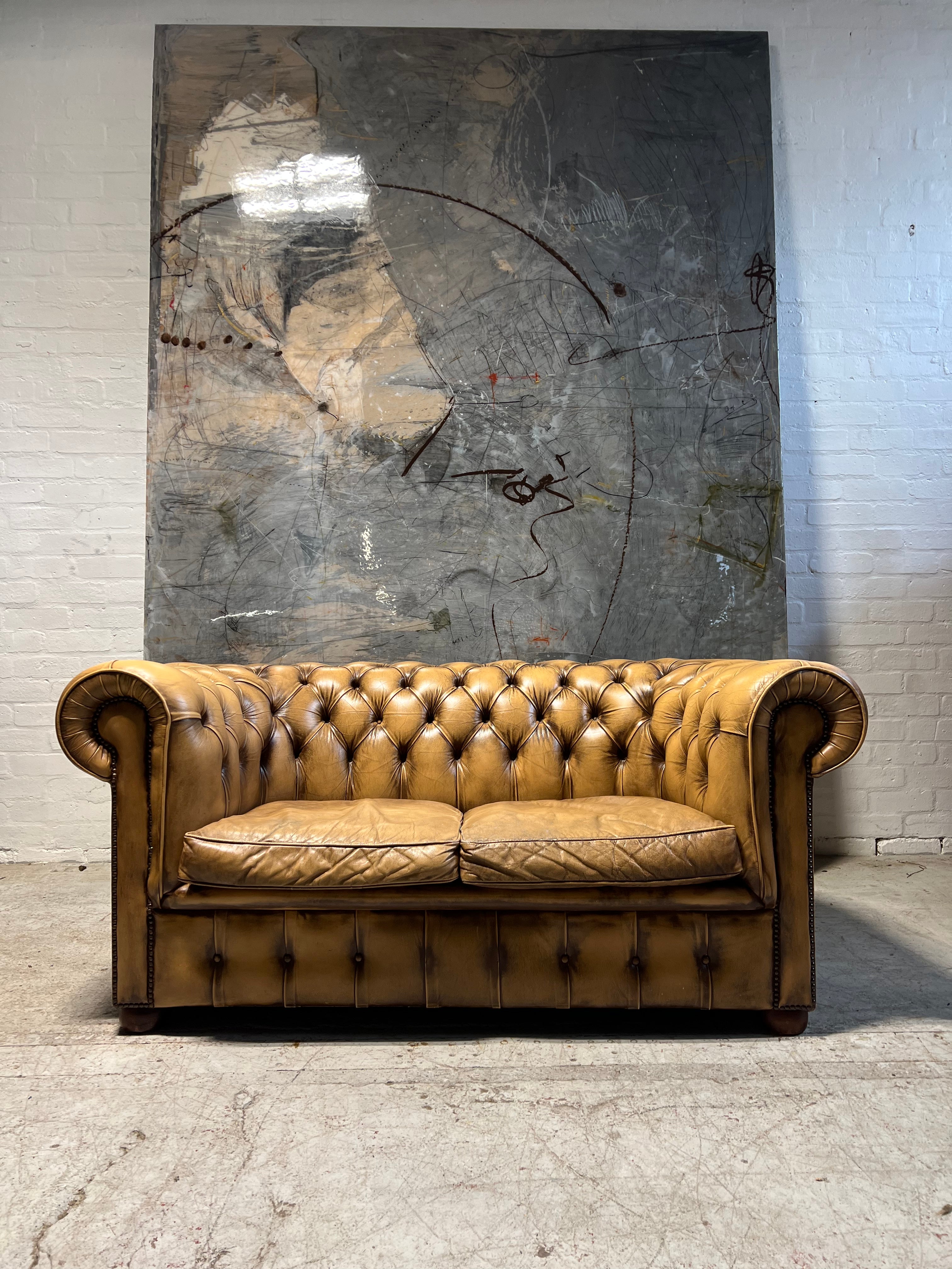 A Great Matching Pair of Light Tan Leather Chesterfield Sofas