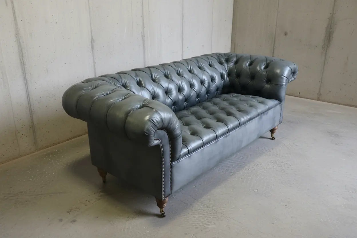 Side angle of grey leather chesterfield sofa