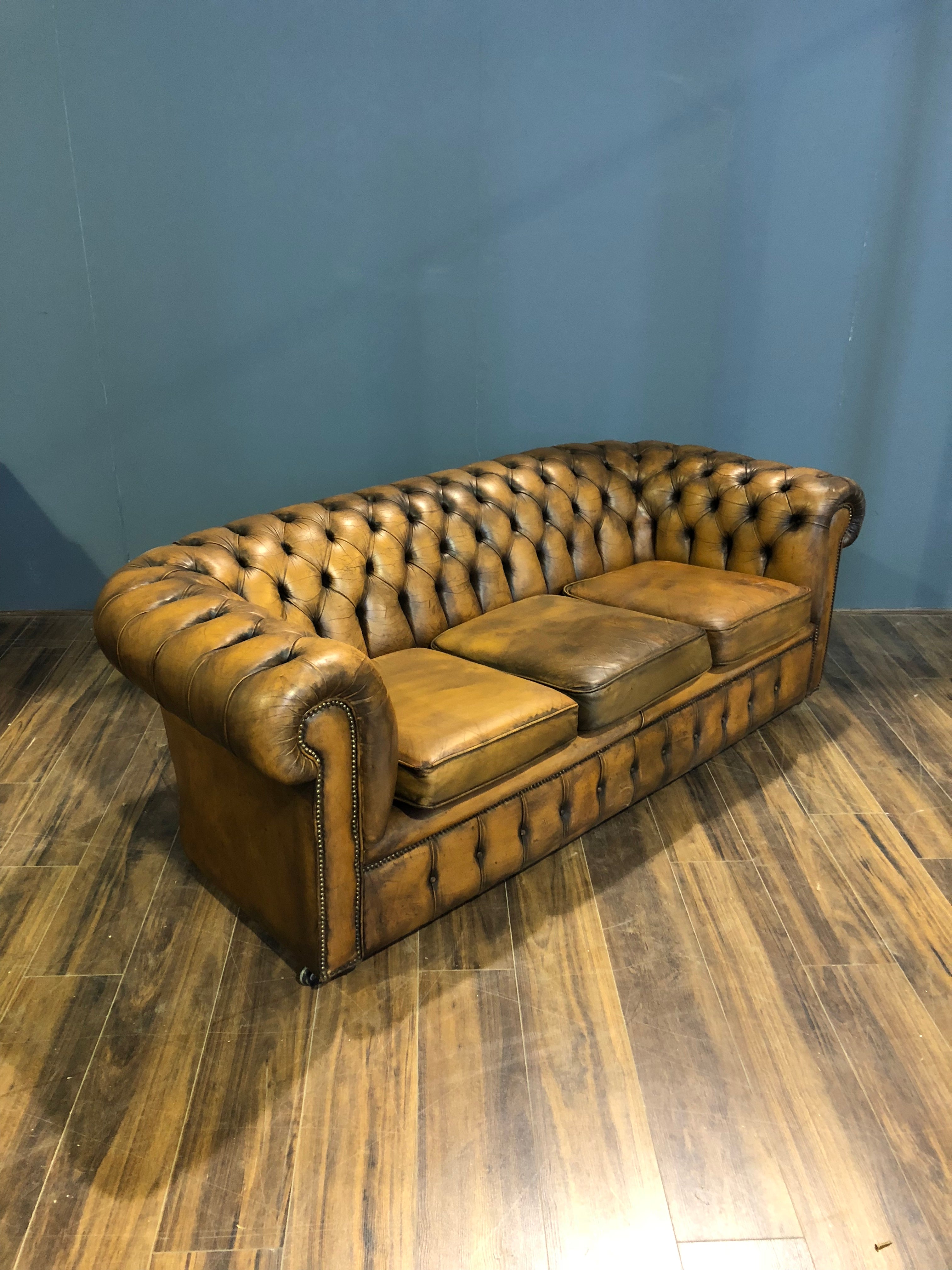 A Very Very Cool Matching Pair of Vintage Leather Chesterfield Sofas in a rustic Golden Tan