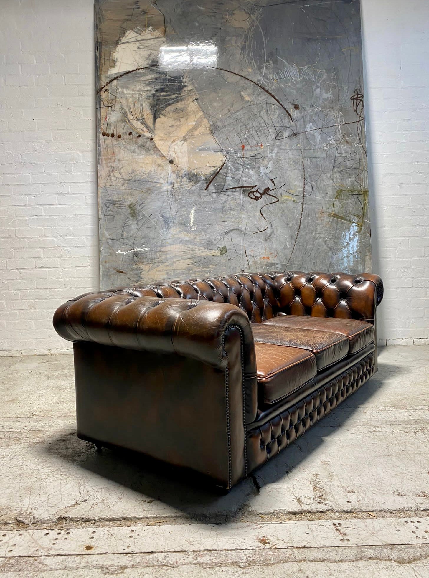 A Lovely Matching Pair of Brown Leather Chesterfield Sofas