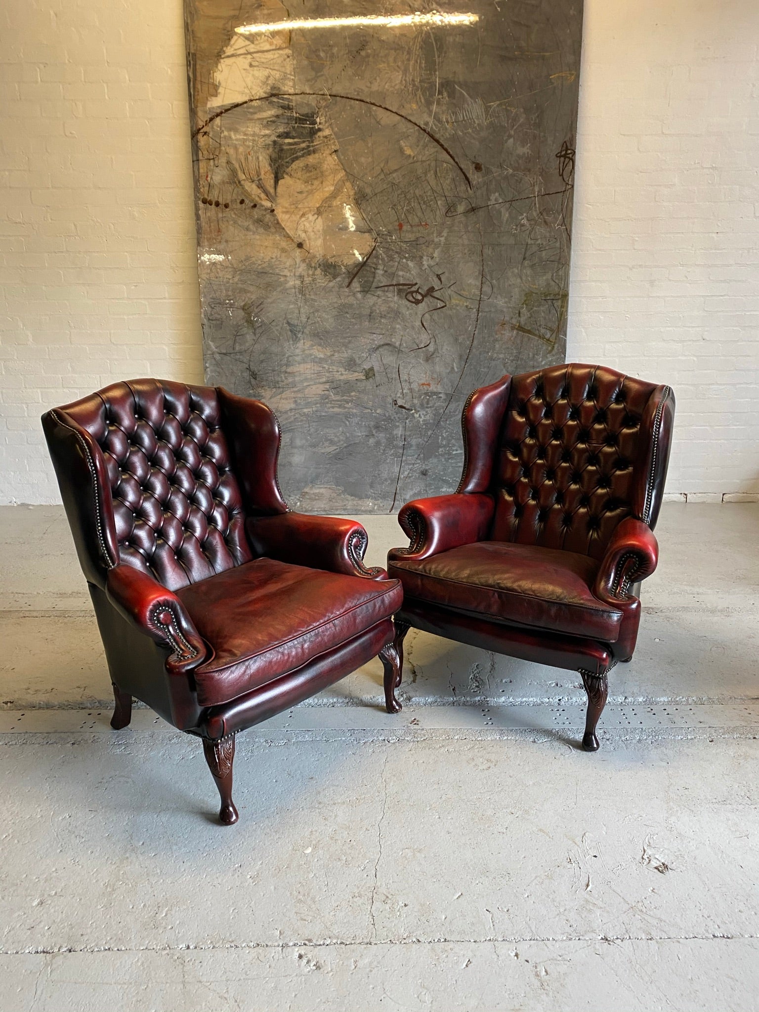 Exceptional Pair of Wing Back Chairs in Wine Reds & Matching Footstools