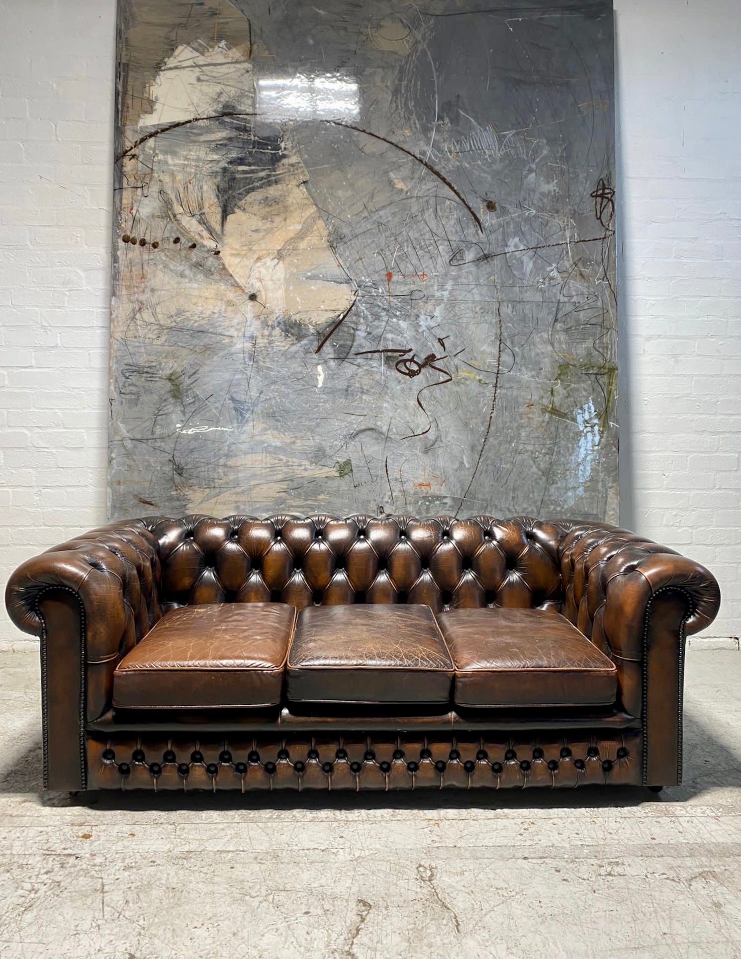 A Lovely Matching Pair of Brown Leather Chesterfield Sofas