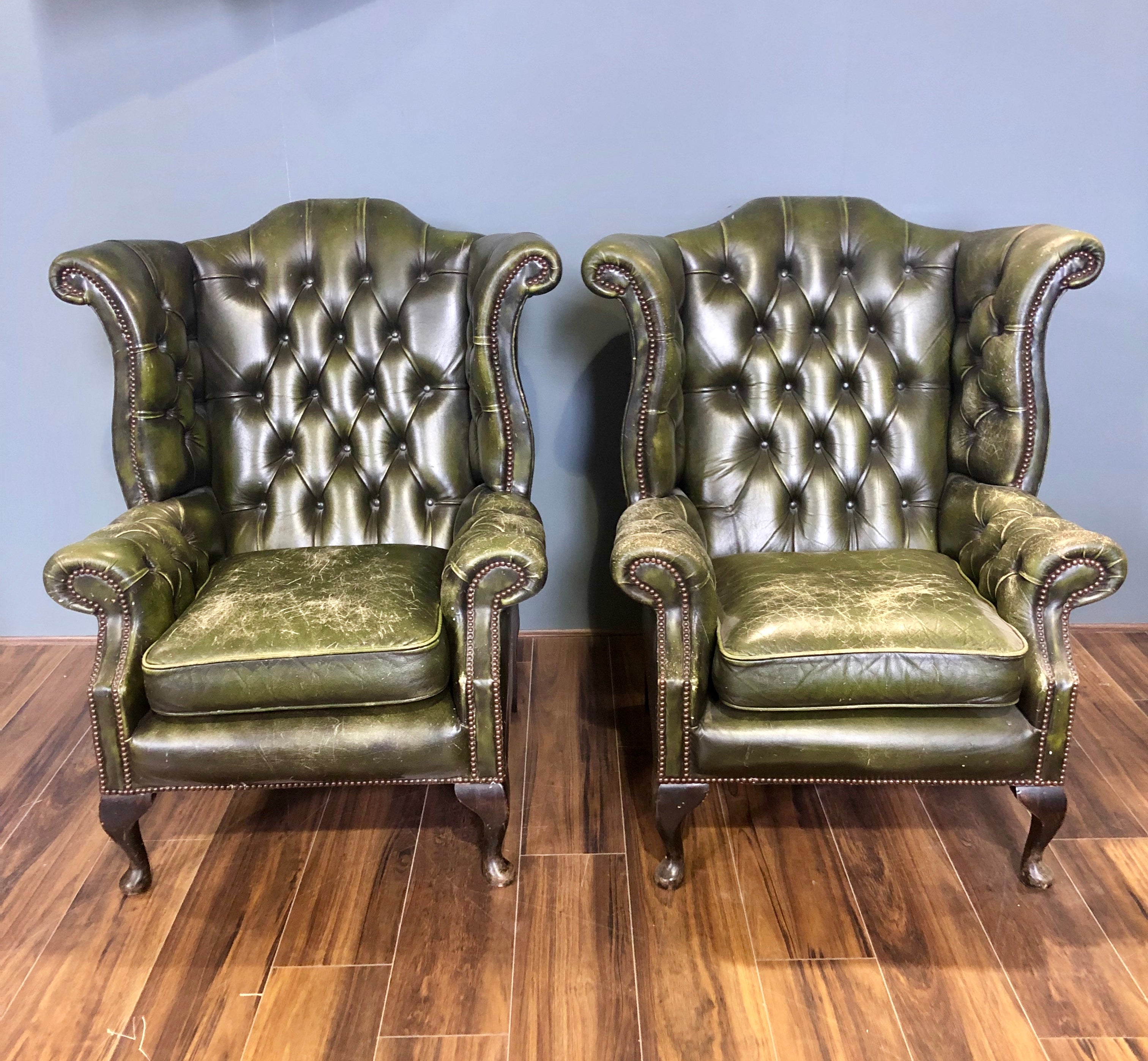 A Character-full Matching Pair of Rich Green Wing Back Chesterfield Chairs