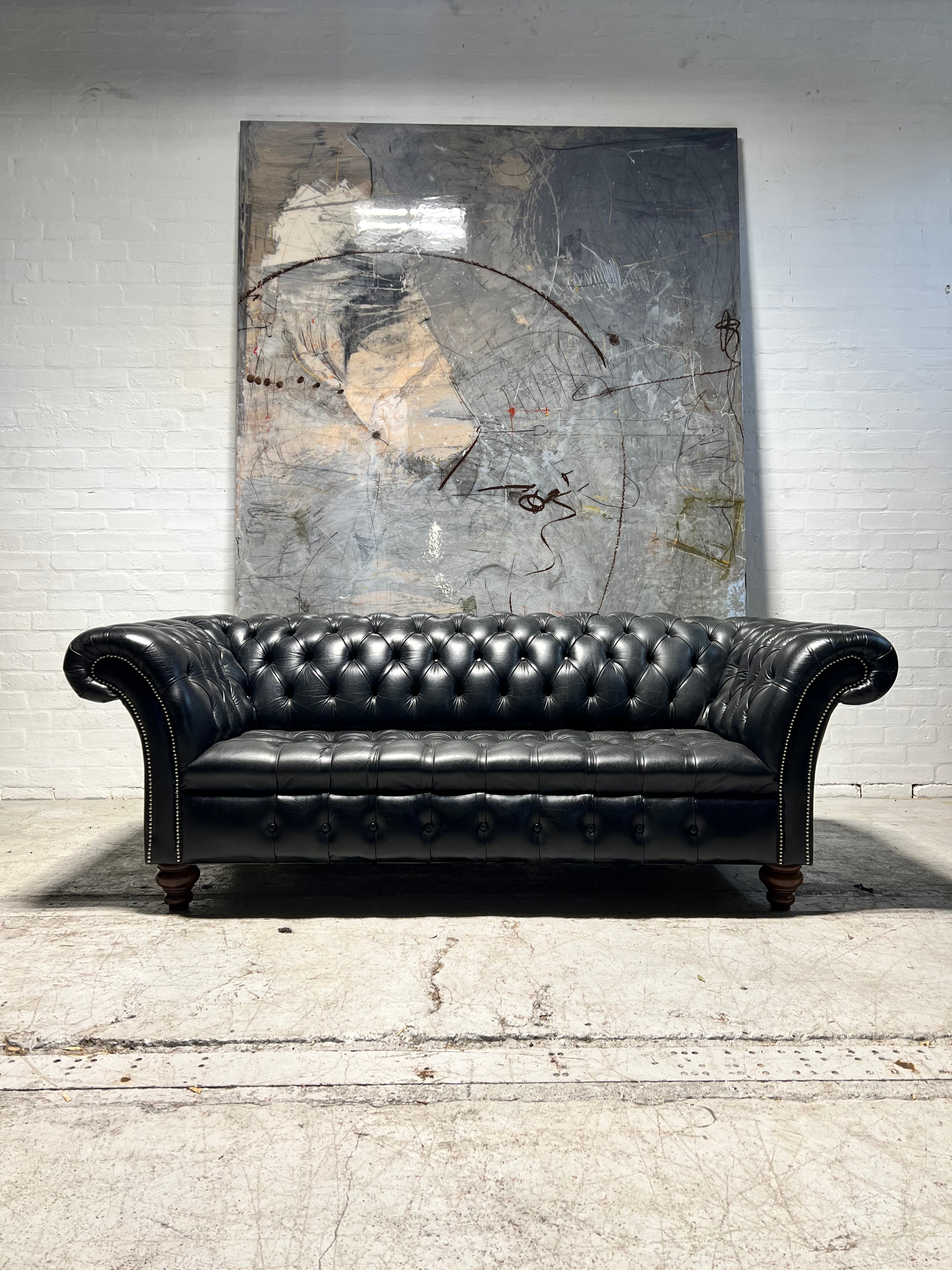 A Pair of Very Smart Black Leather Chesterfield Sofas