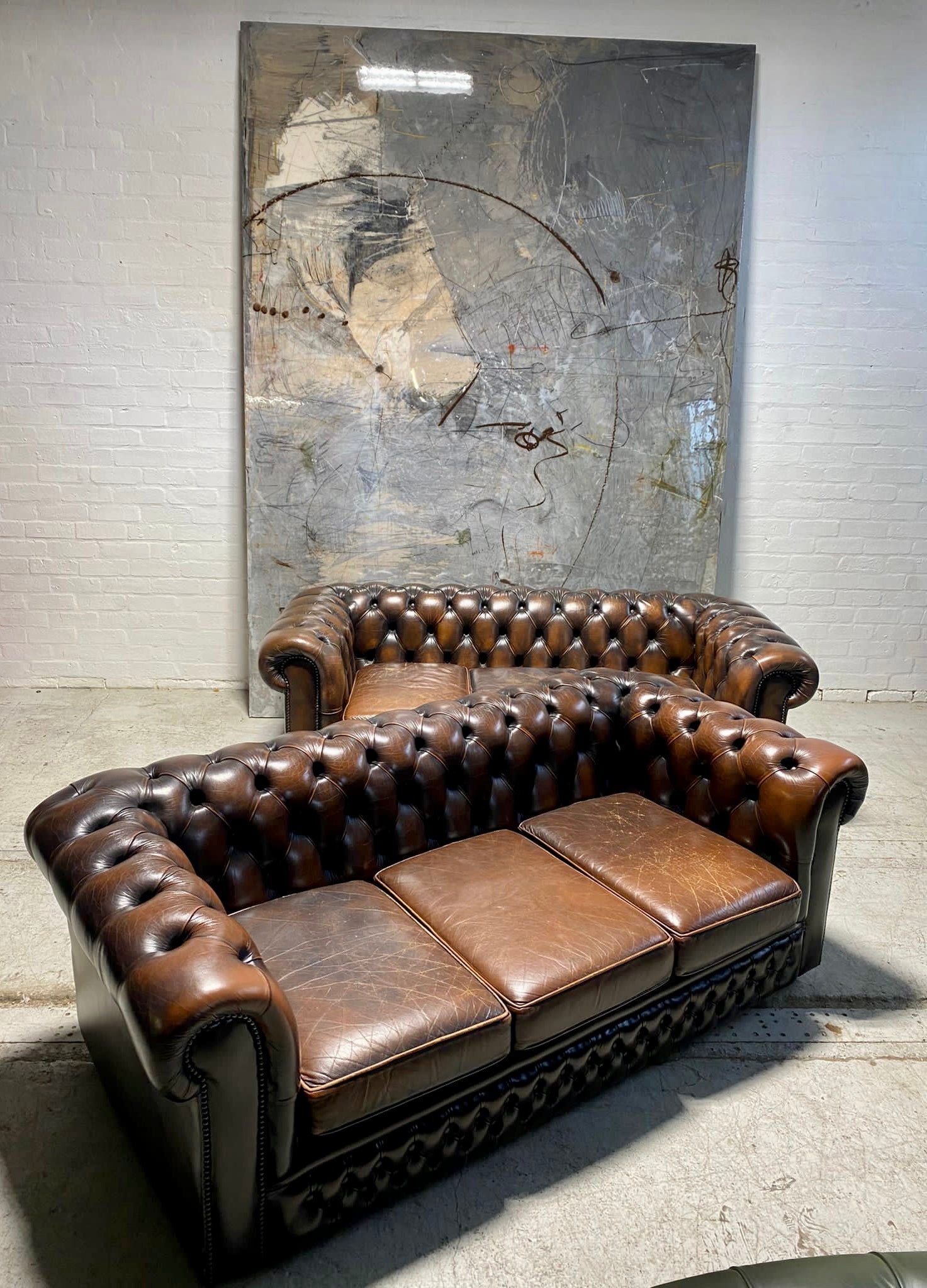 A Lovely Matching Pair of Brown Leather Chesterfield Sofas