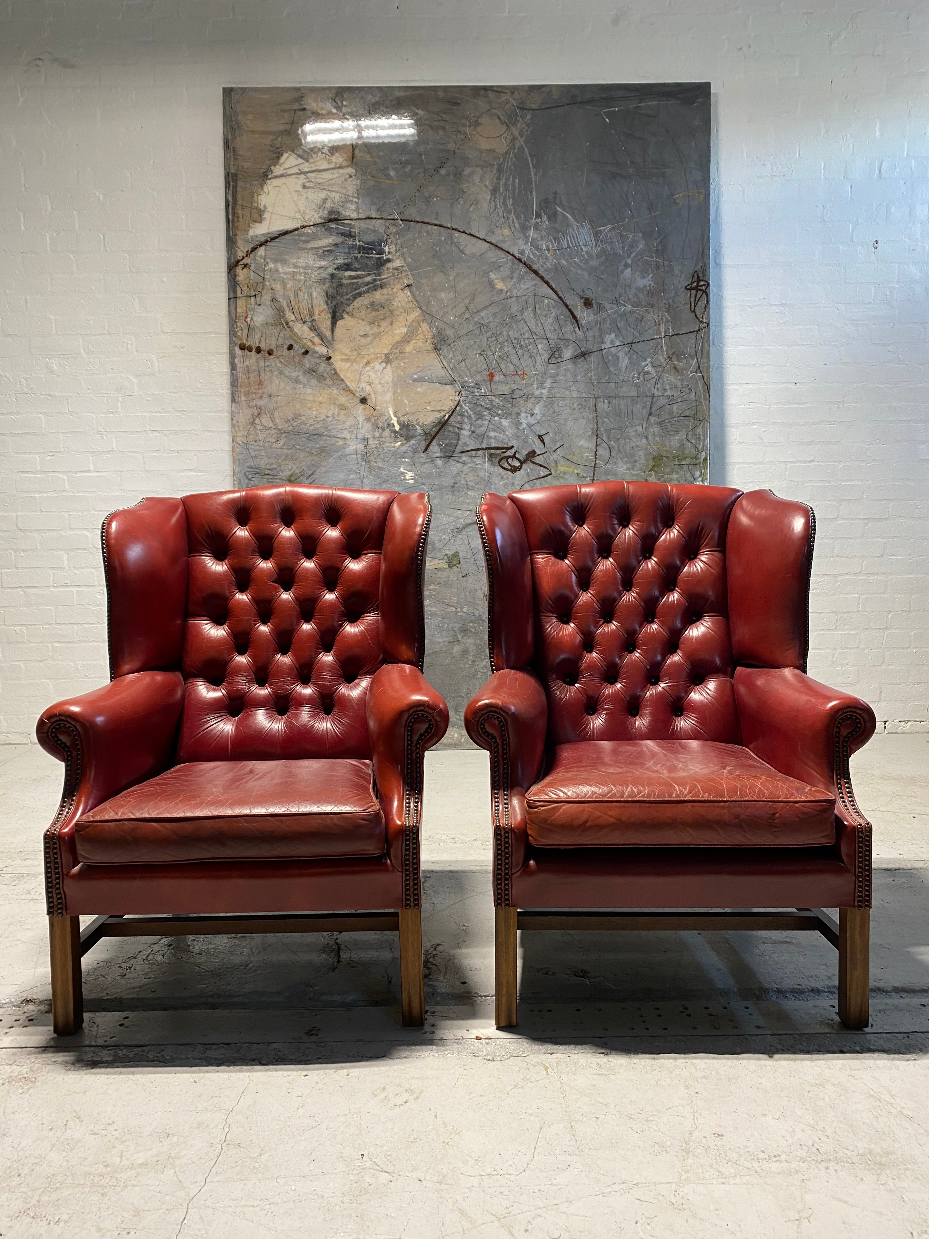 A Very Good Matching Pair of MidC Gentleman’s Wing Chairs in Raspberry Leather