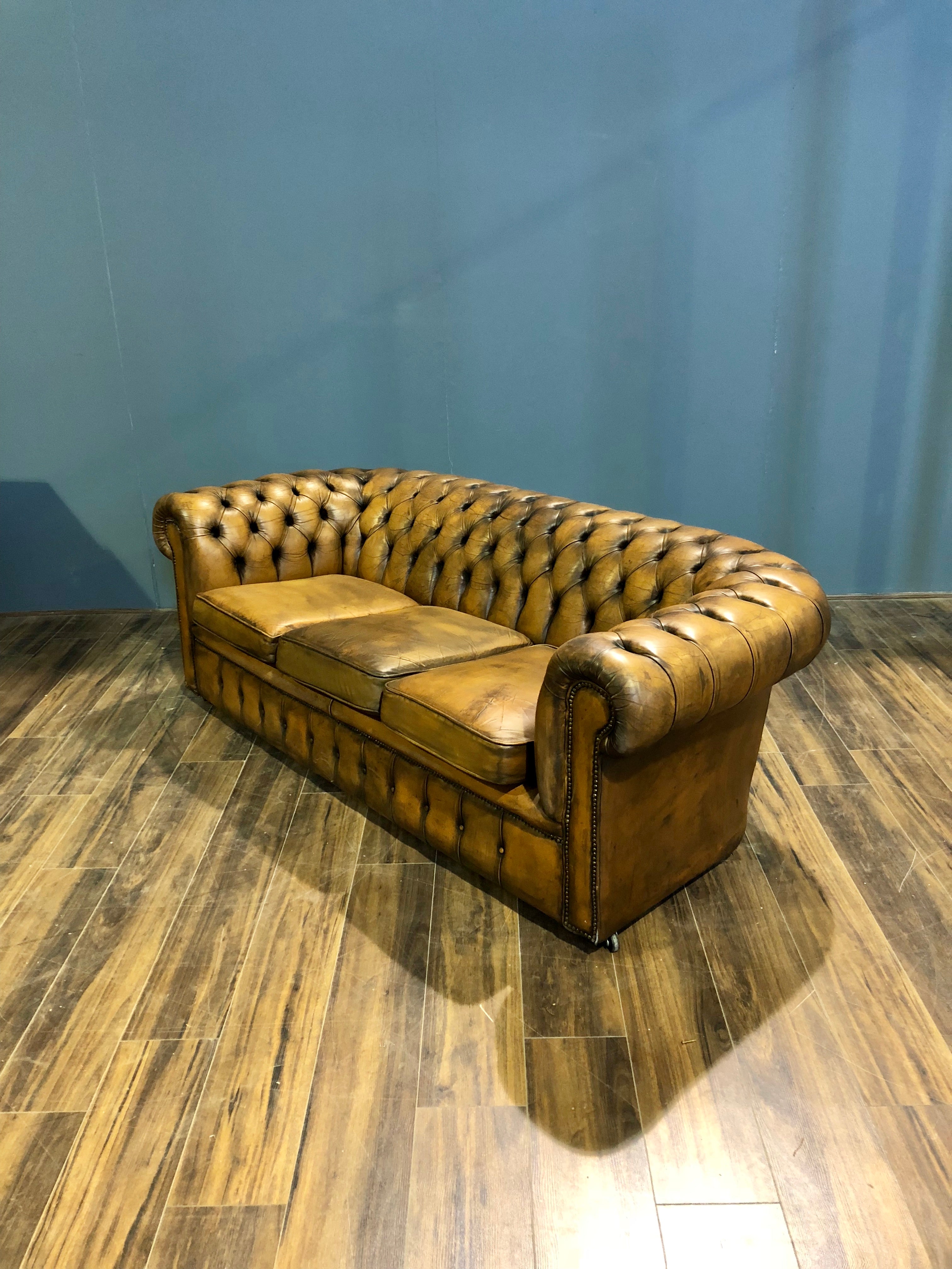 A Very Very Cool Matching Pair of Vintage Leather Chesterfield Sofas in a rustic Golden Tan