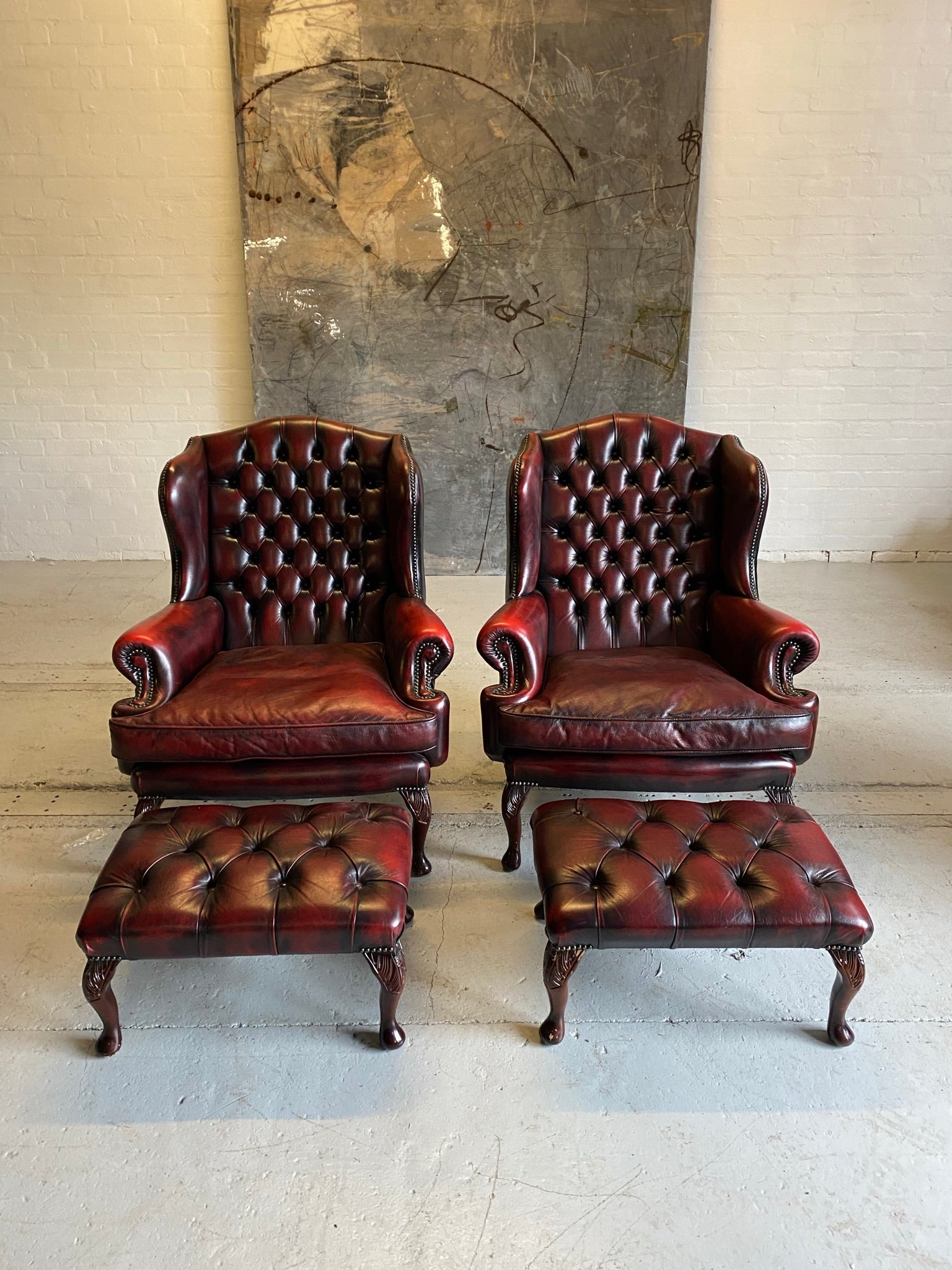 Exceptional Pair of Wing Back Chairs in Wine Reds & Matching Footstools