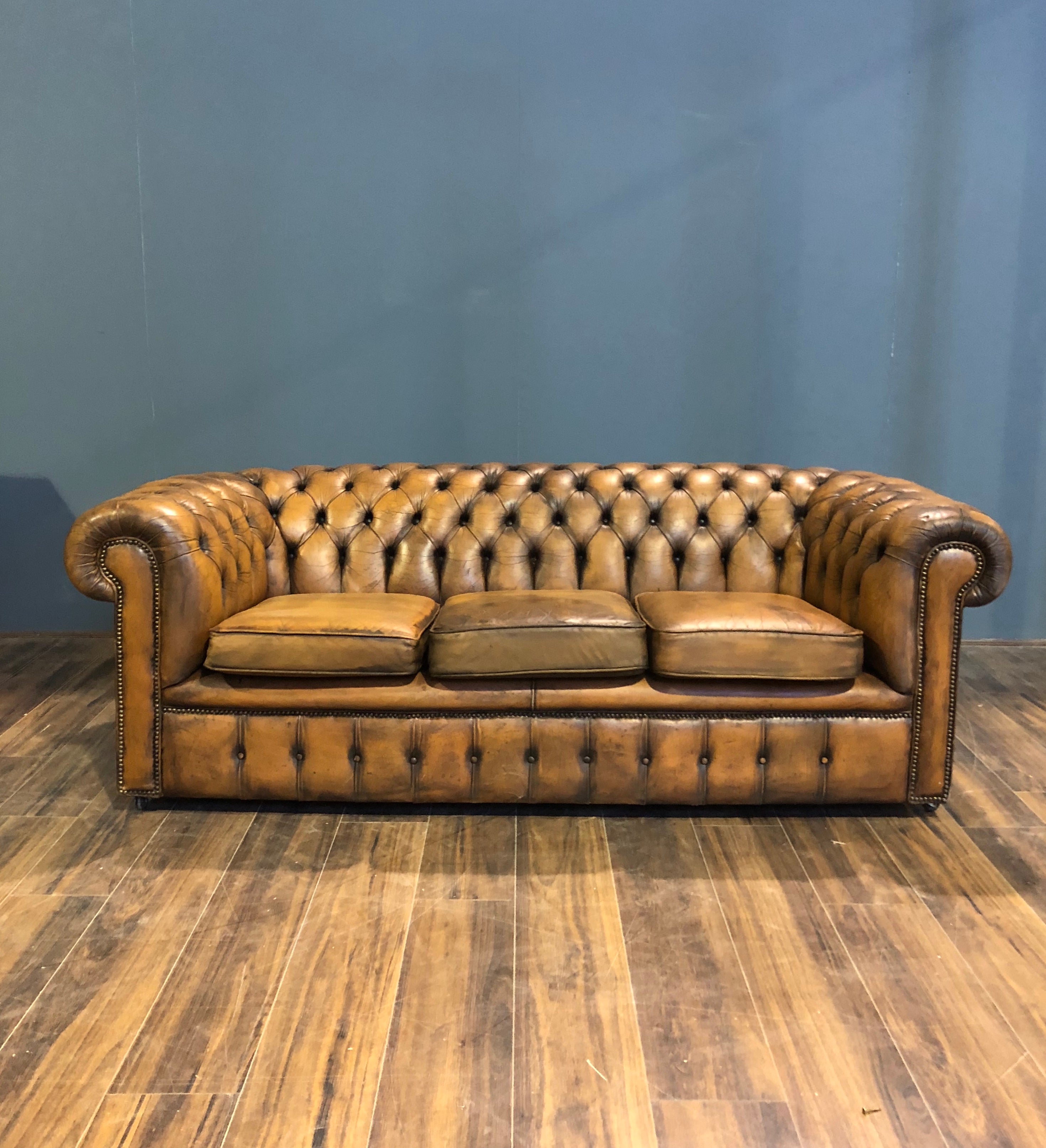 A Very Very Cool Matching Pair of Vintage Leather Chesterfield Sofas in a rustic Golden Tan