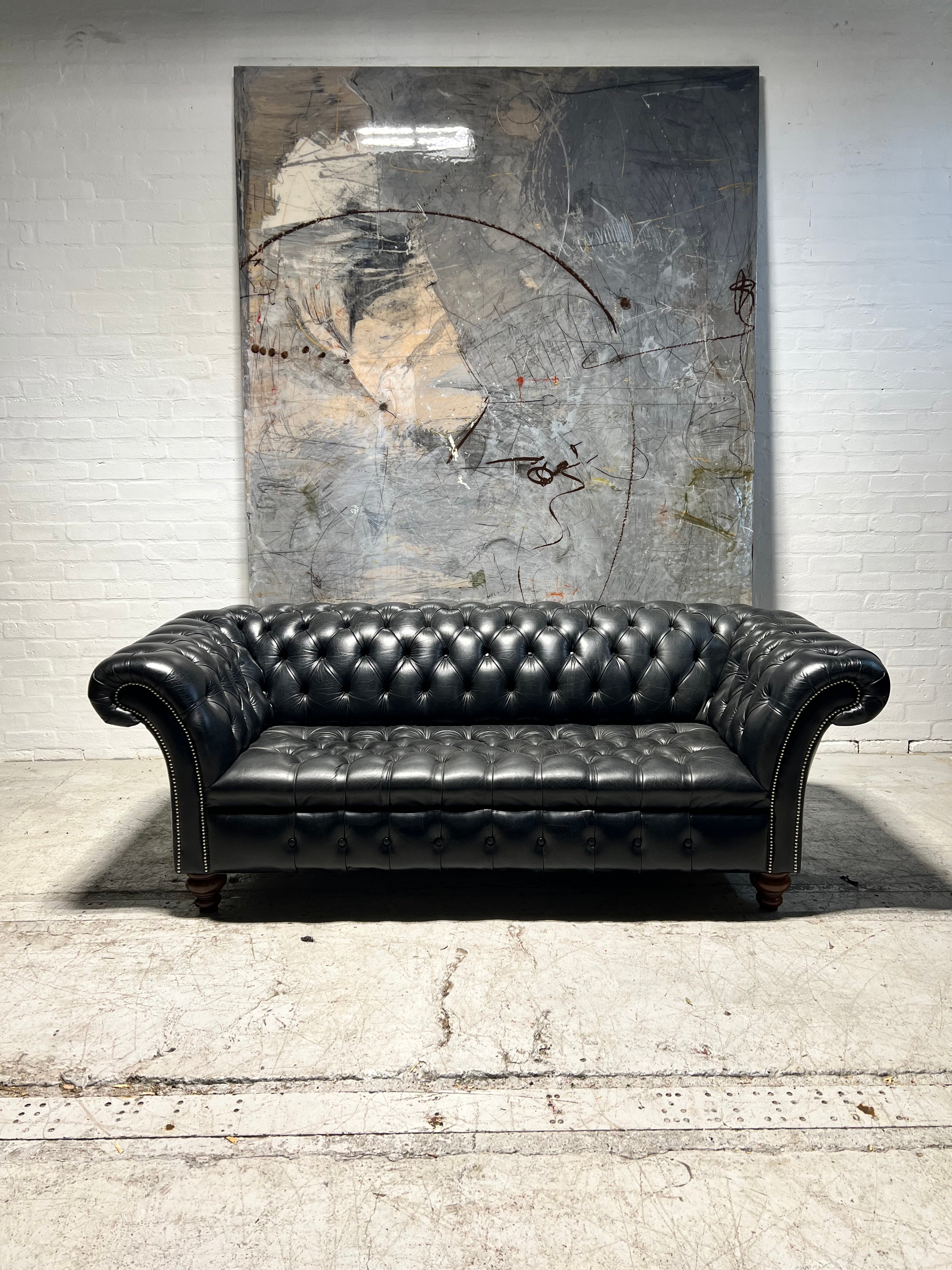 A Pair of Very Smart Black Leather Chesterfield Sofas