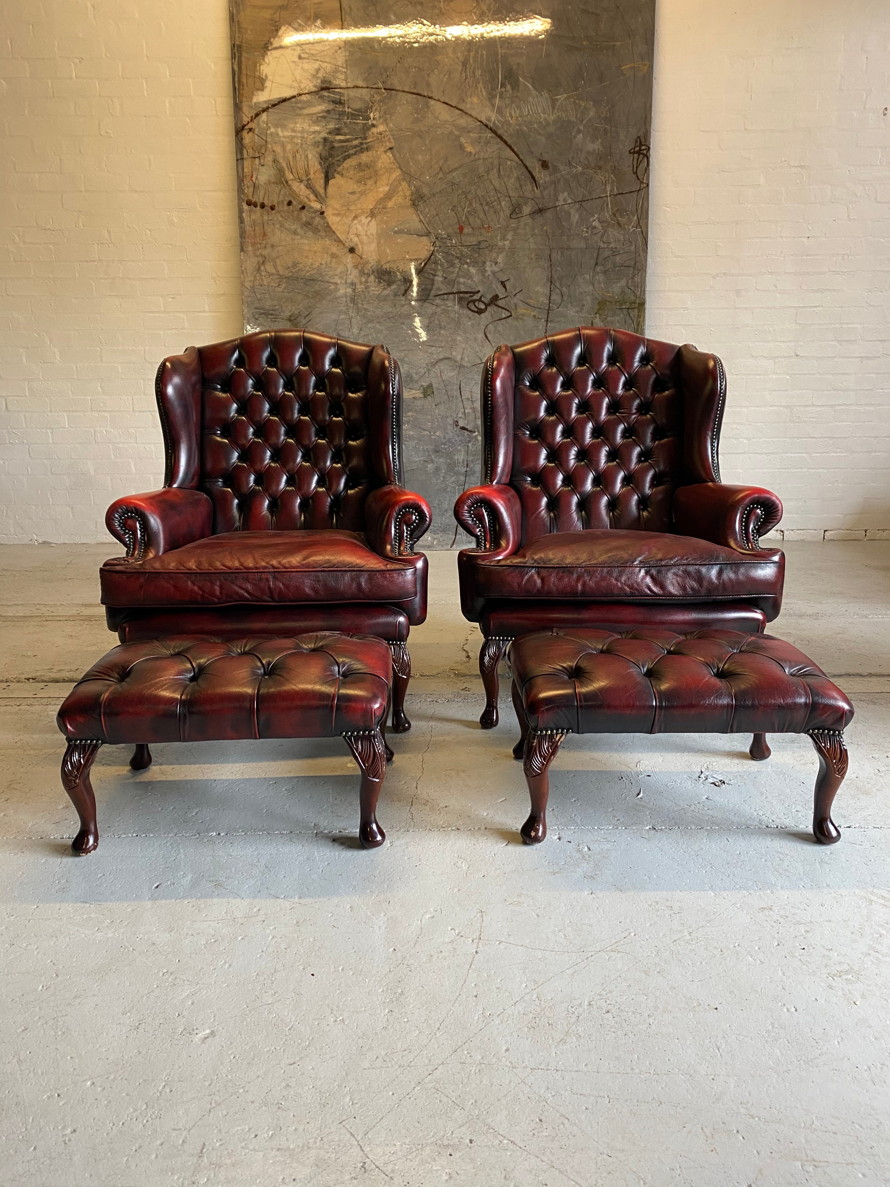 Exceptional Pair of Wing Back Chairs in Wine Reds & Matching Footstools