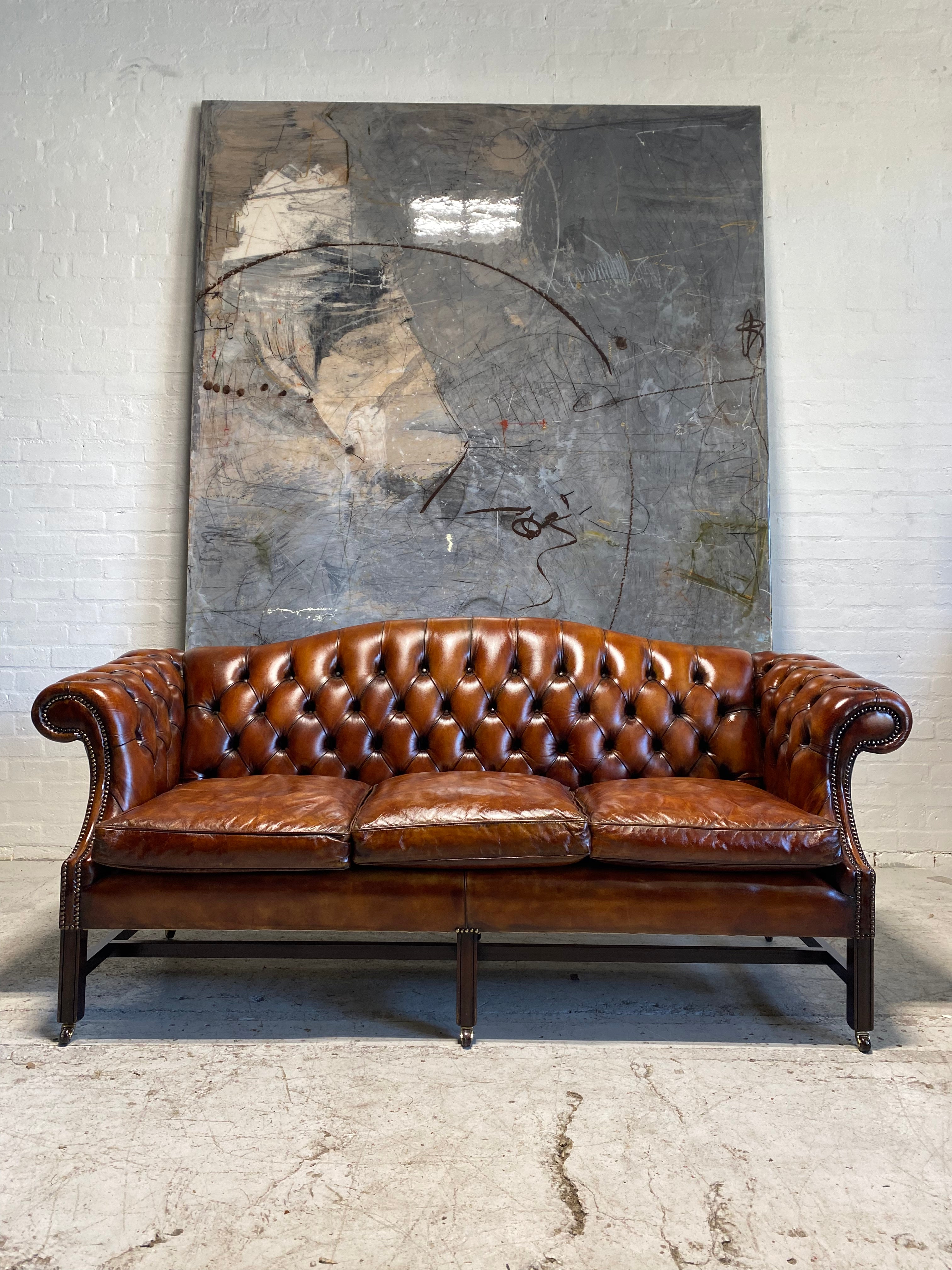 A Stunning MidC Chippendale Camel Back Hand Dyed Leather Sofa