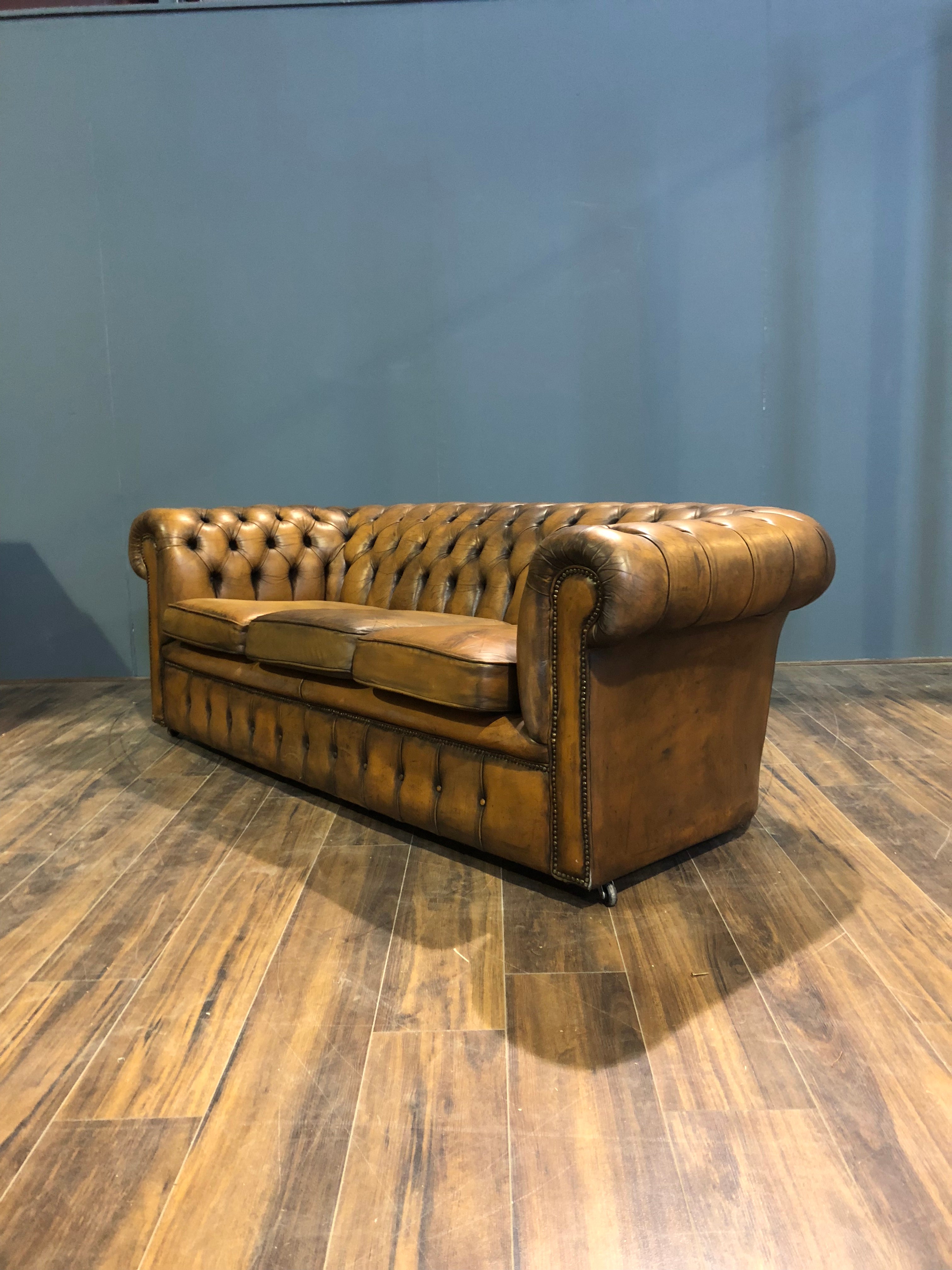 A Very Very Cool Matching Pair of Vintage Leather Chesterfield Sofas in a rustic Golden Tan