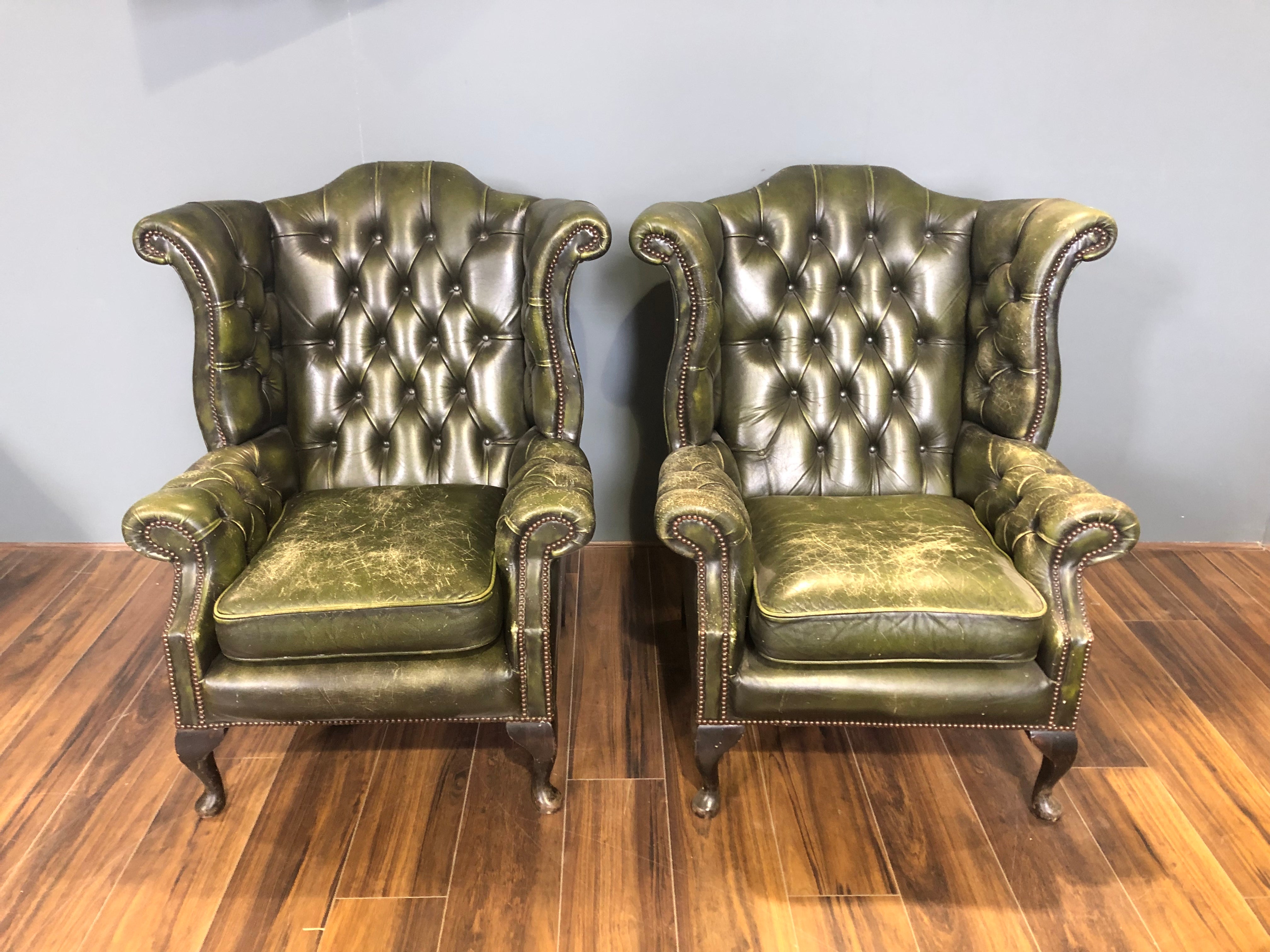 A Character-full Matching Pair of Rich Green Wing Back Chesterfield Chairs