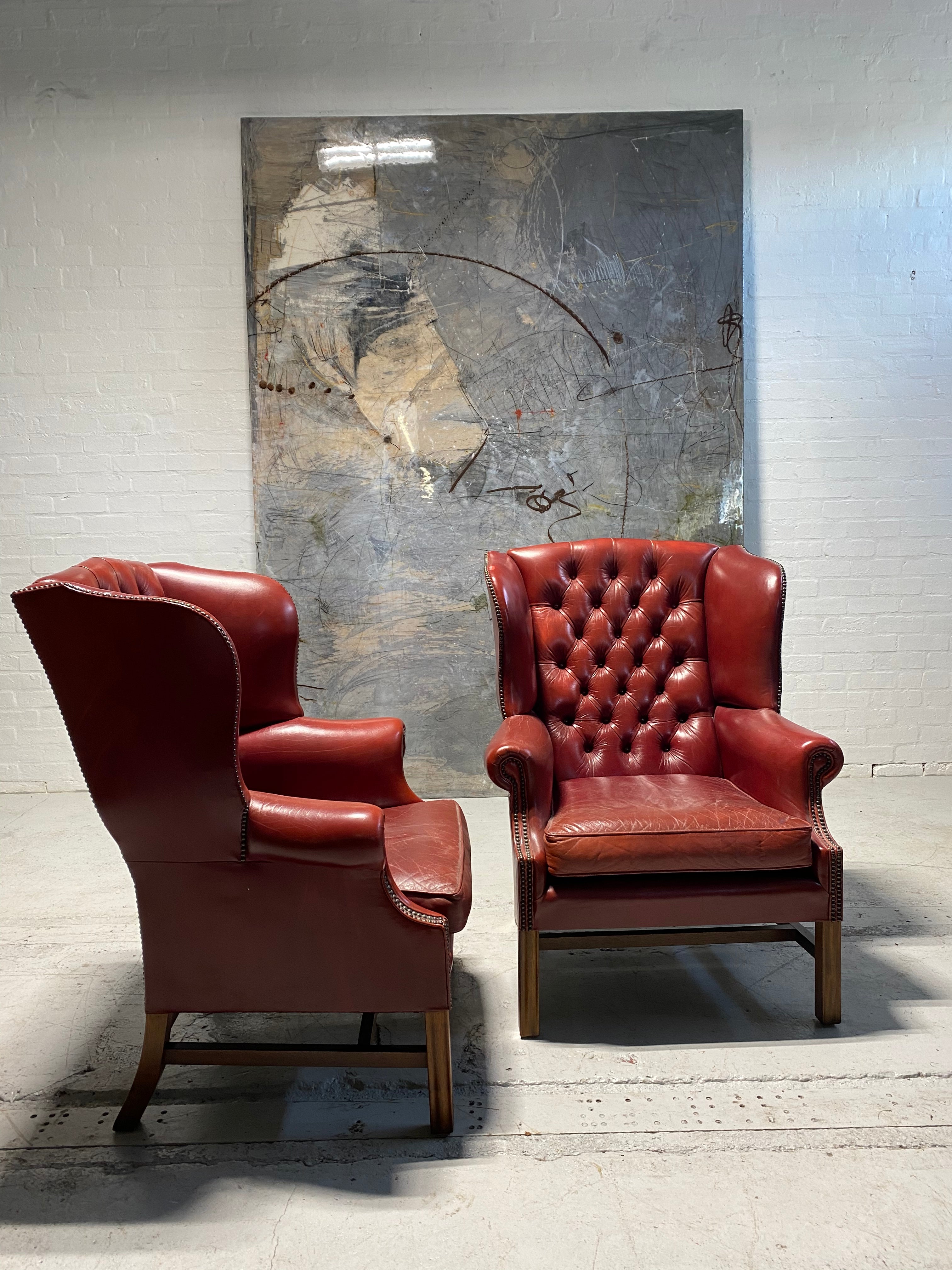 A Very Good Matching Pair of MidC Gentleman’s Wing Chairs in Raspberry Leather