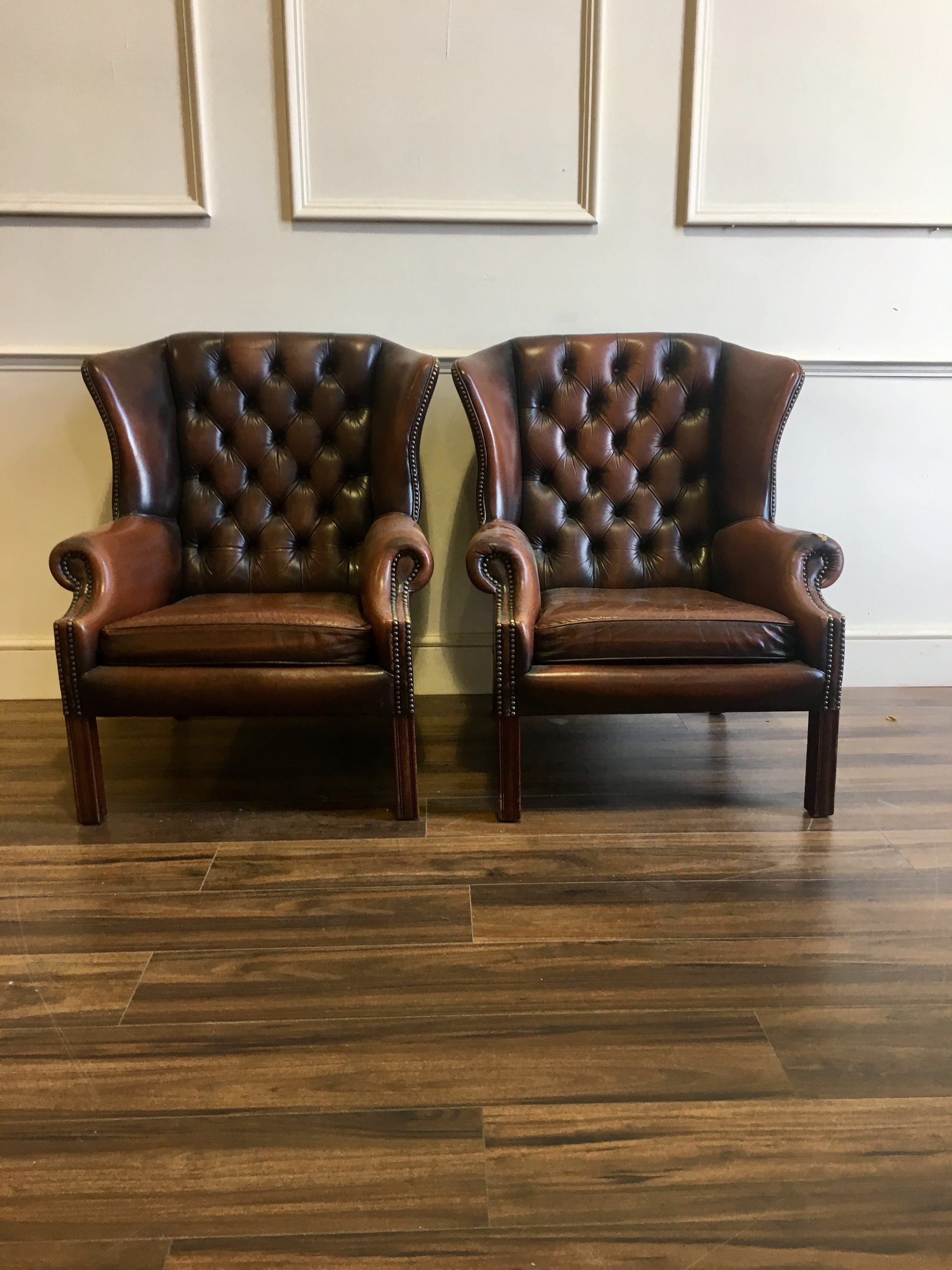 A Super Matching Pair of Leather Chesterfield Wing Back Chairs